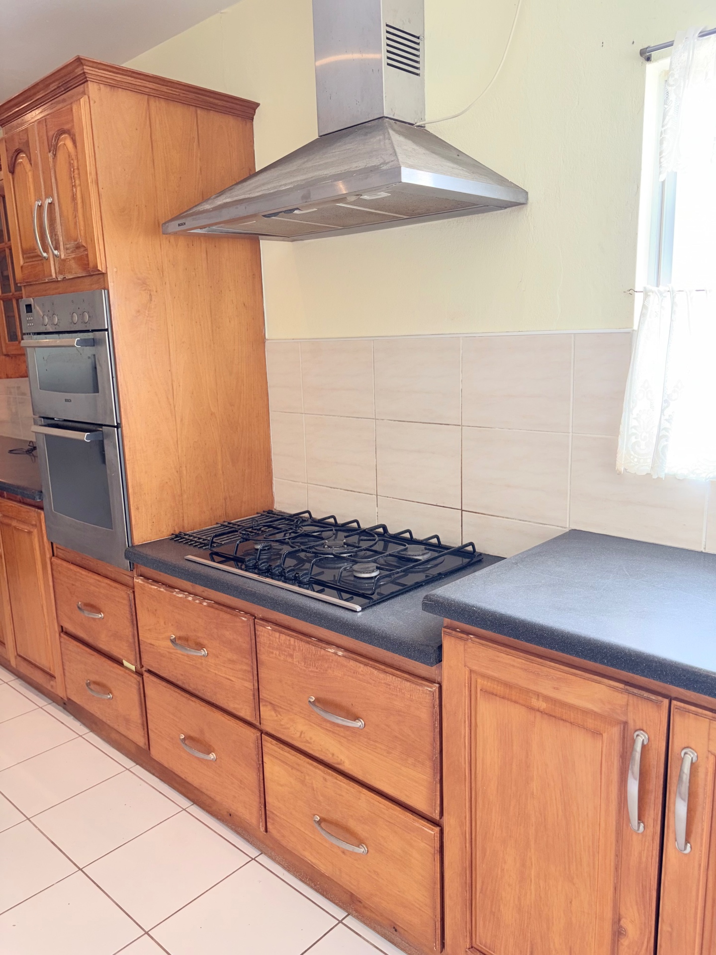 Kitchen detail with gas cooktop and stainless hood