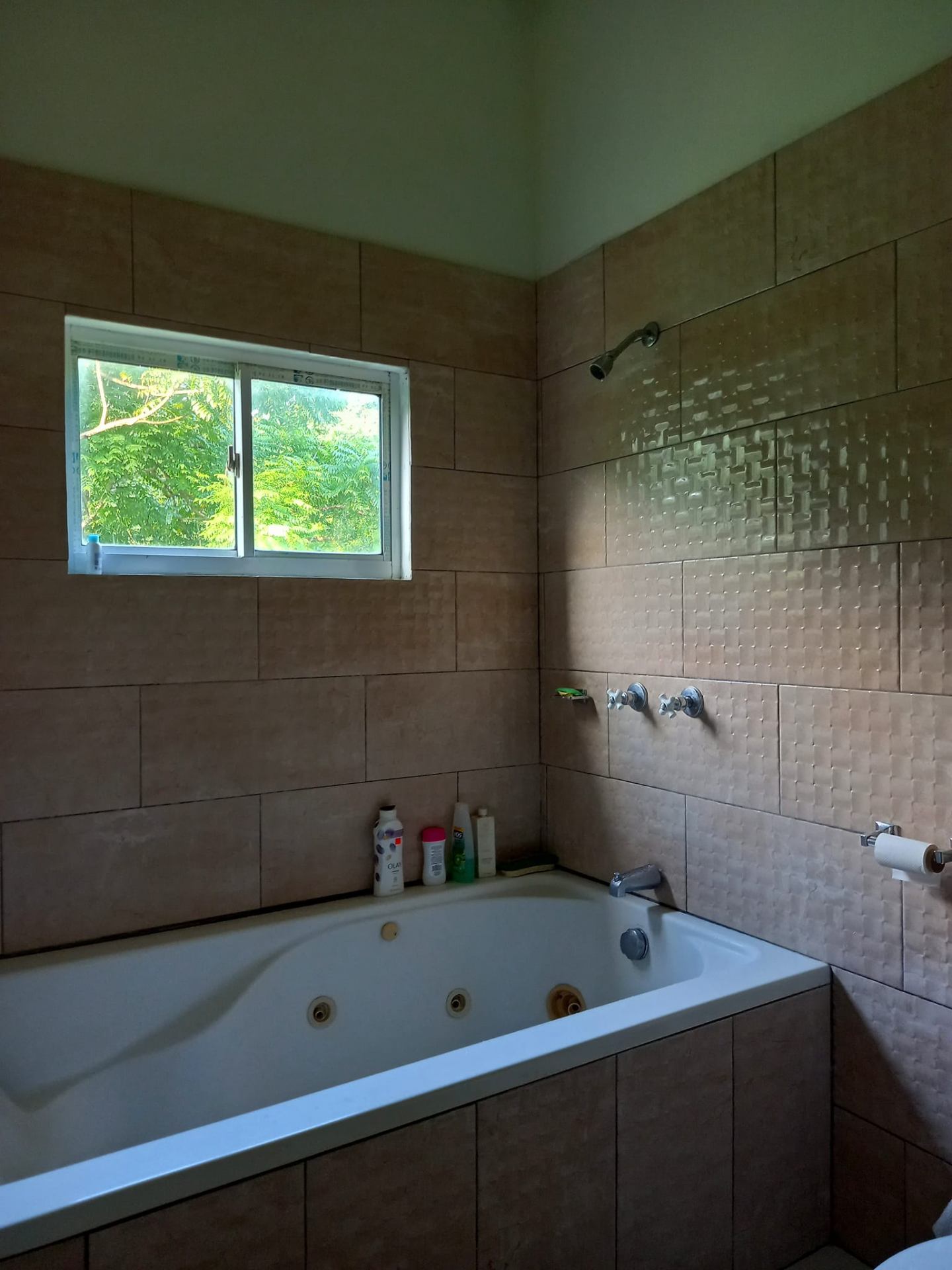 Bathroom with jetted tub and tiled walls