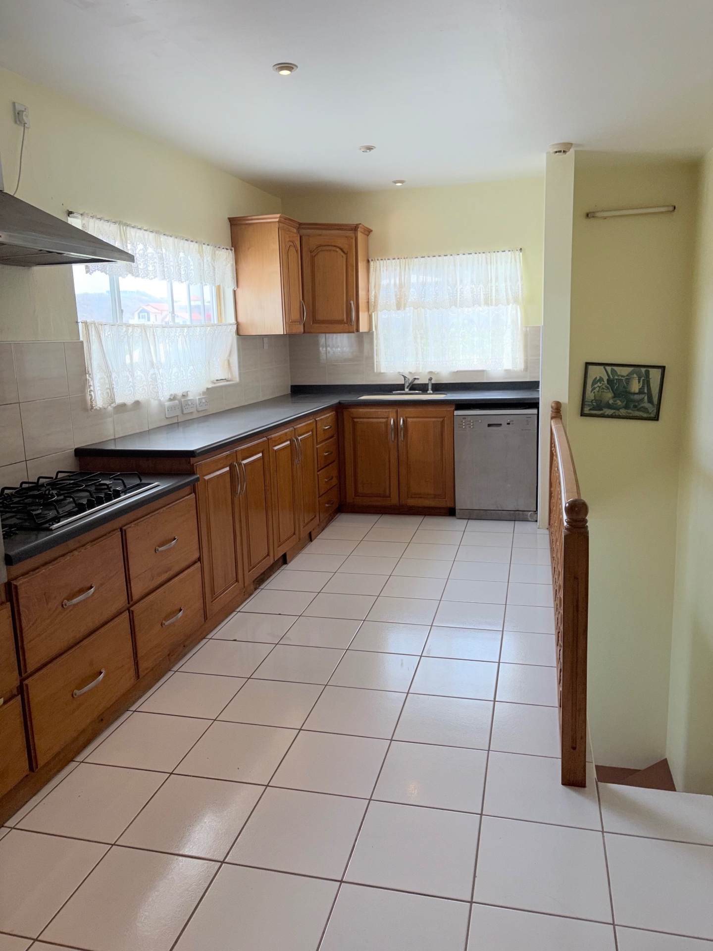 Large kitchen with wood cabinetry and tiled floors
