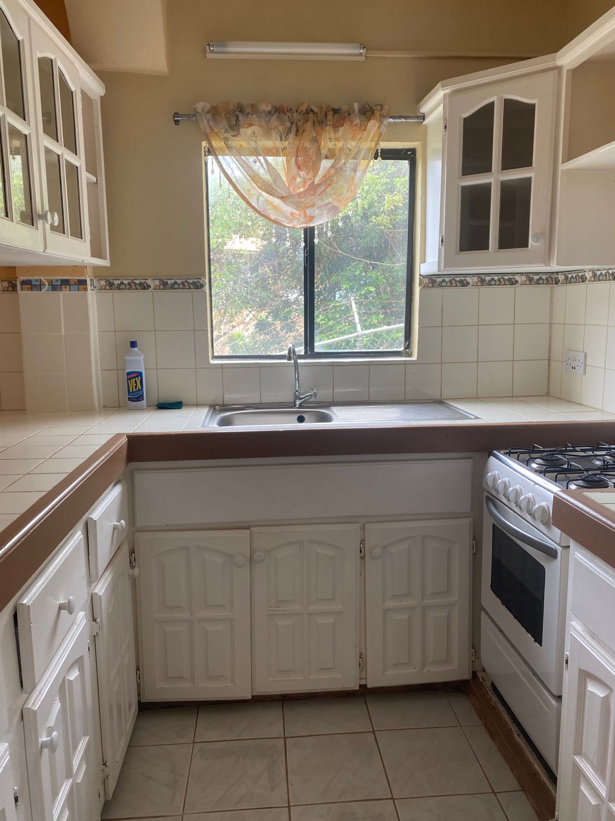 Kitchen sink area with faucet and counter space
