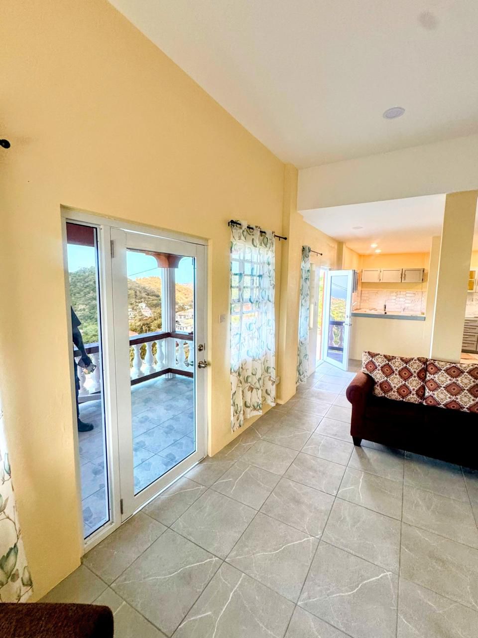 Balcony entrance with hillside and ocean views