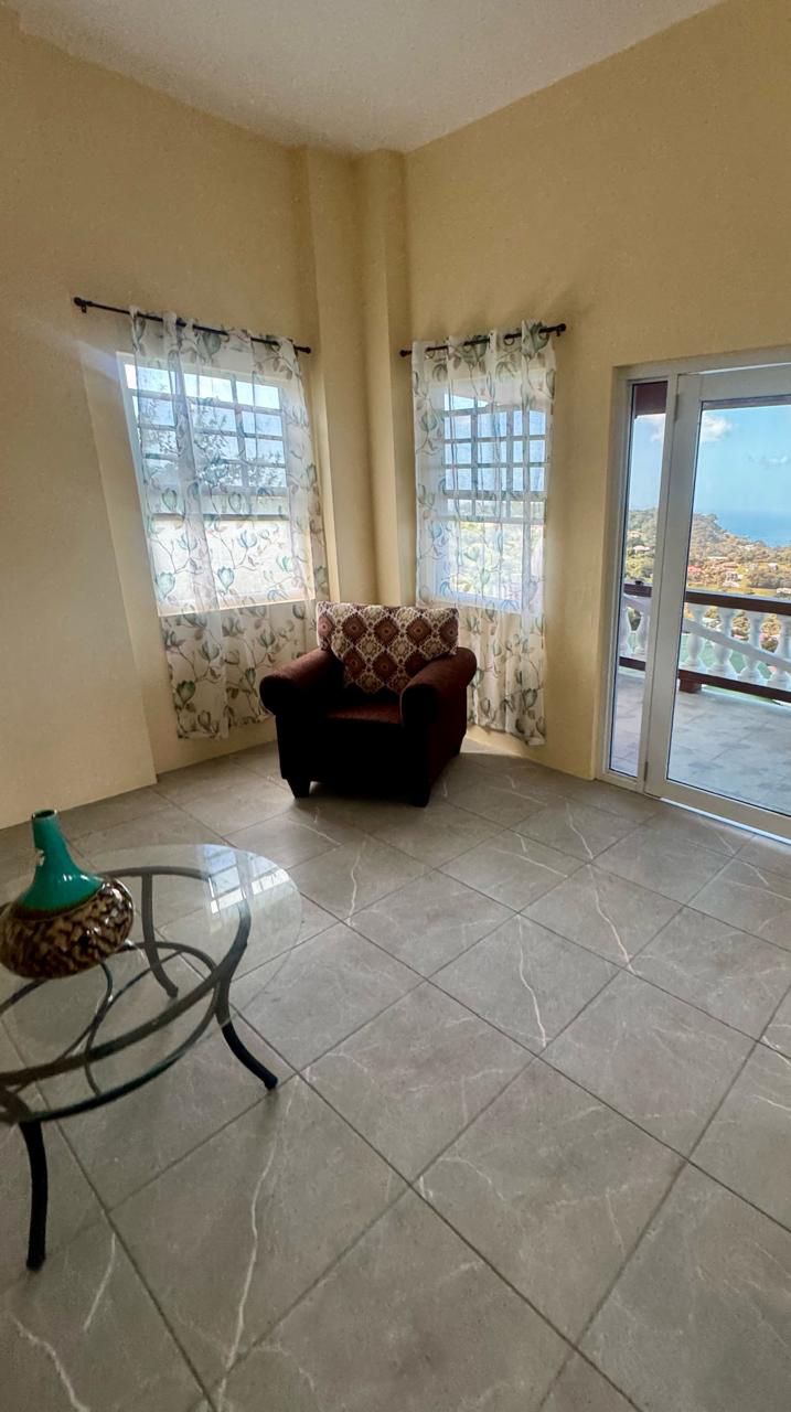 Sitting area with sliding doors opening to a sea view