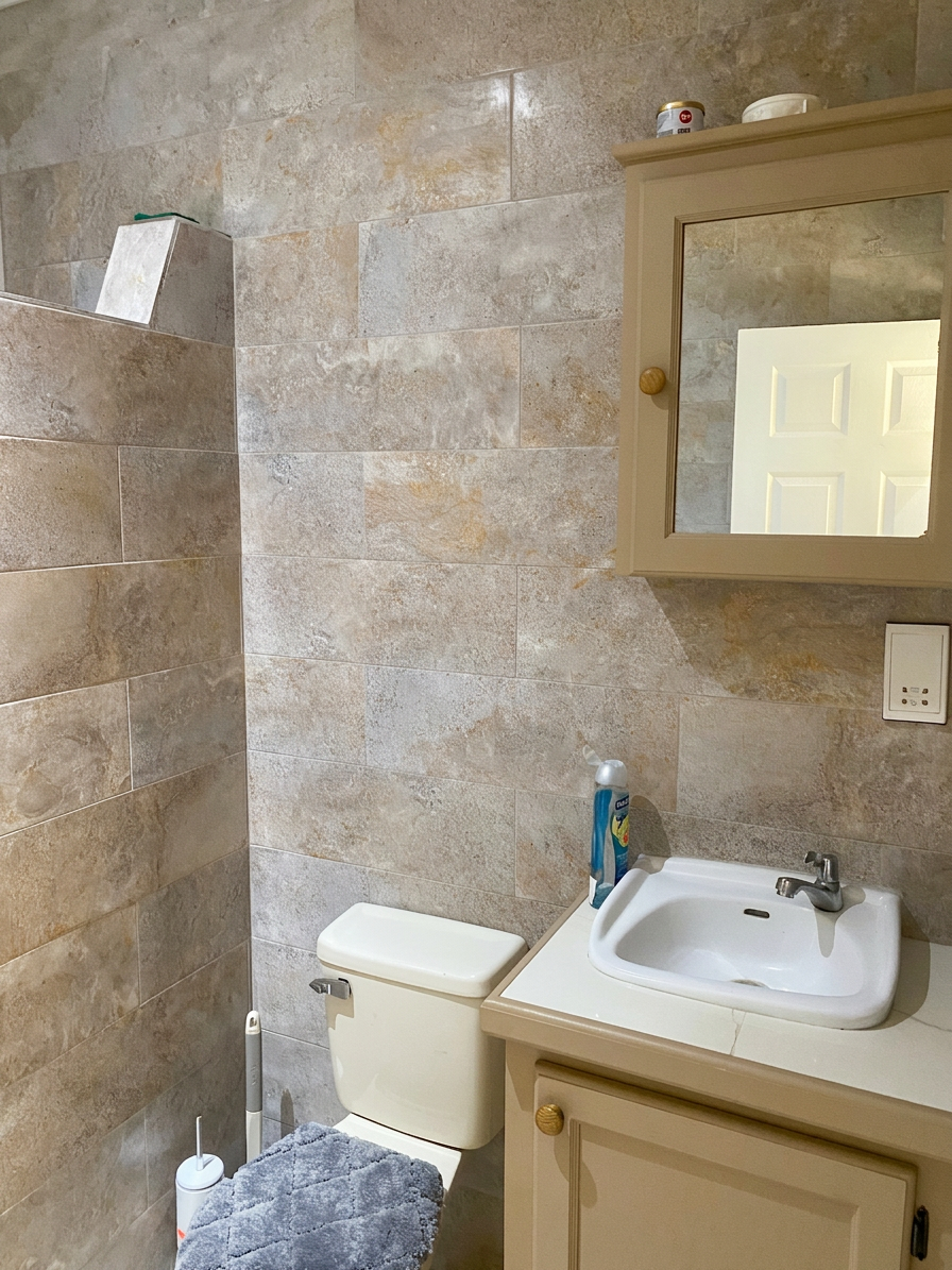 Clean modern bathroom with tiled walls, vanity and mirror cabinet