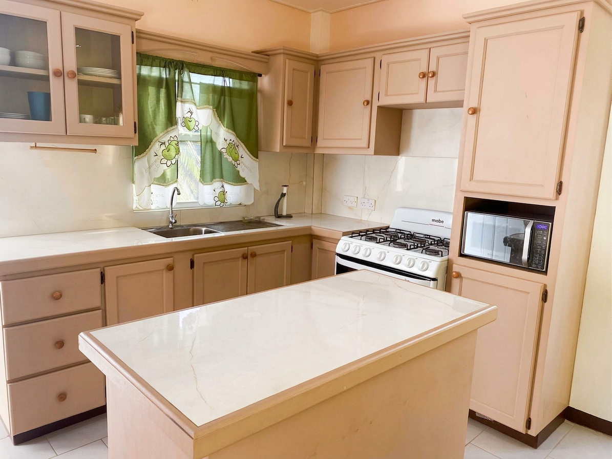 Spacious modern kitchen with island, gas stove and ample cabinetry