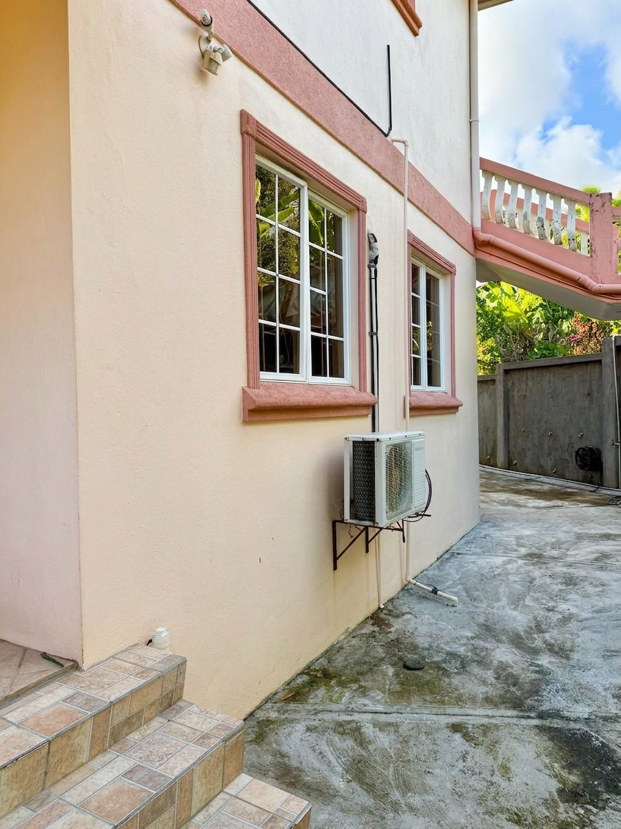 Pastel exterior with windows and side patio