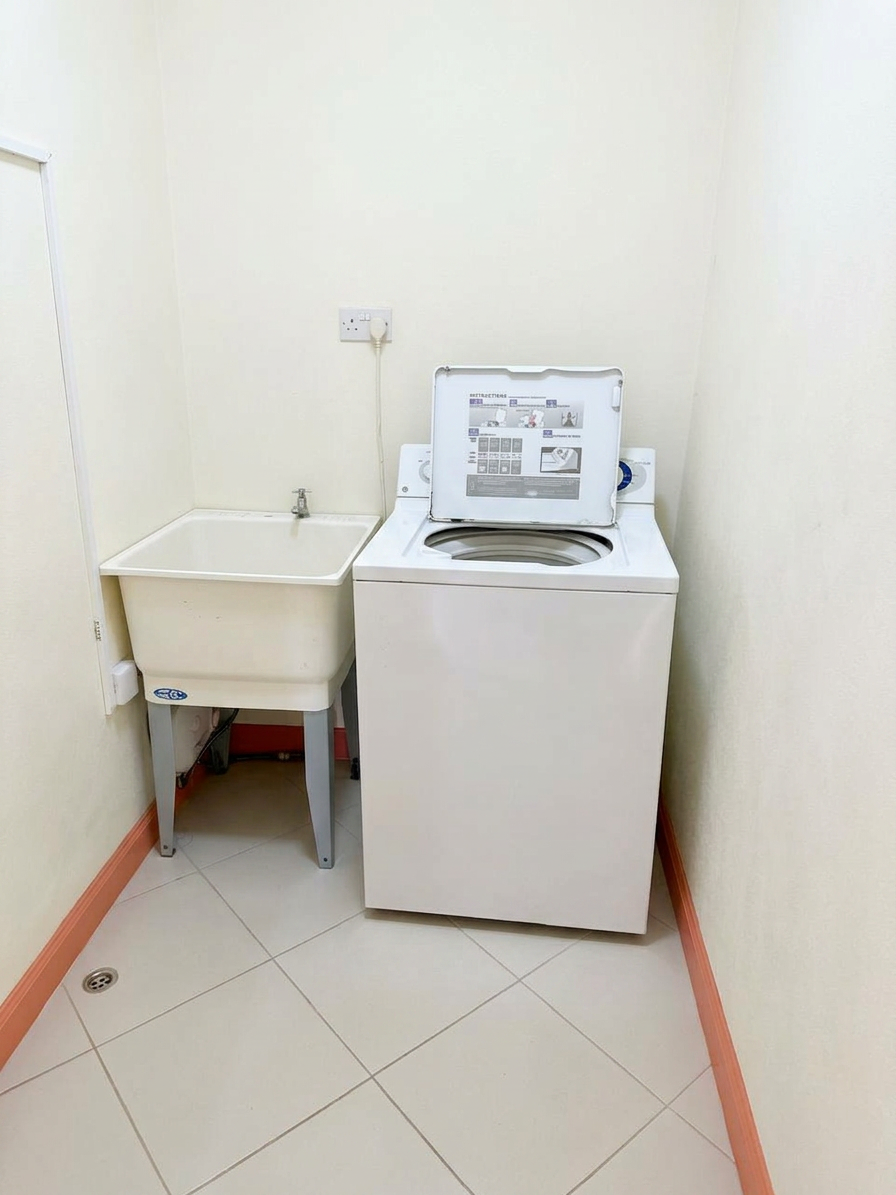 Private laundry room with washing machine and utility sink