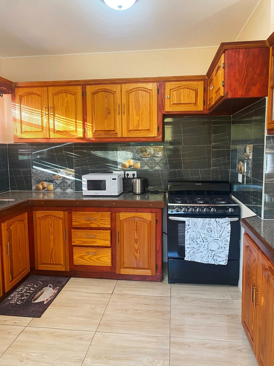Kitchen with gas range, microwave and ample wood cabinetry