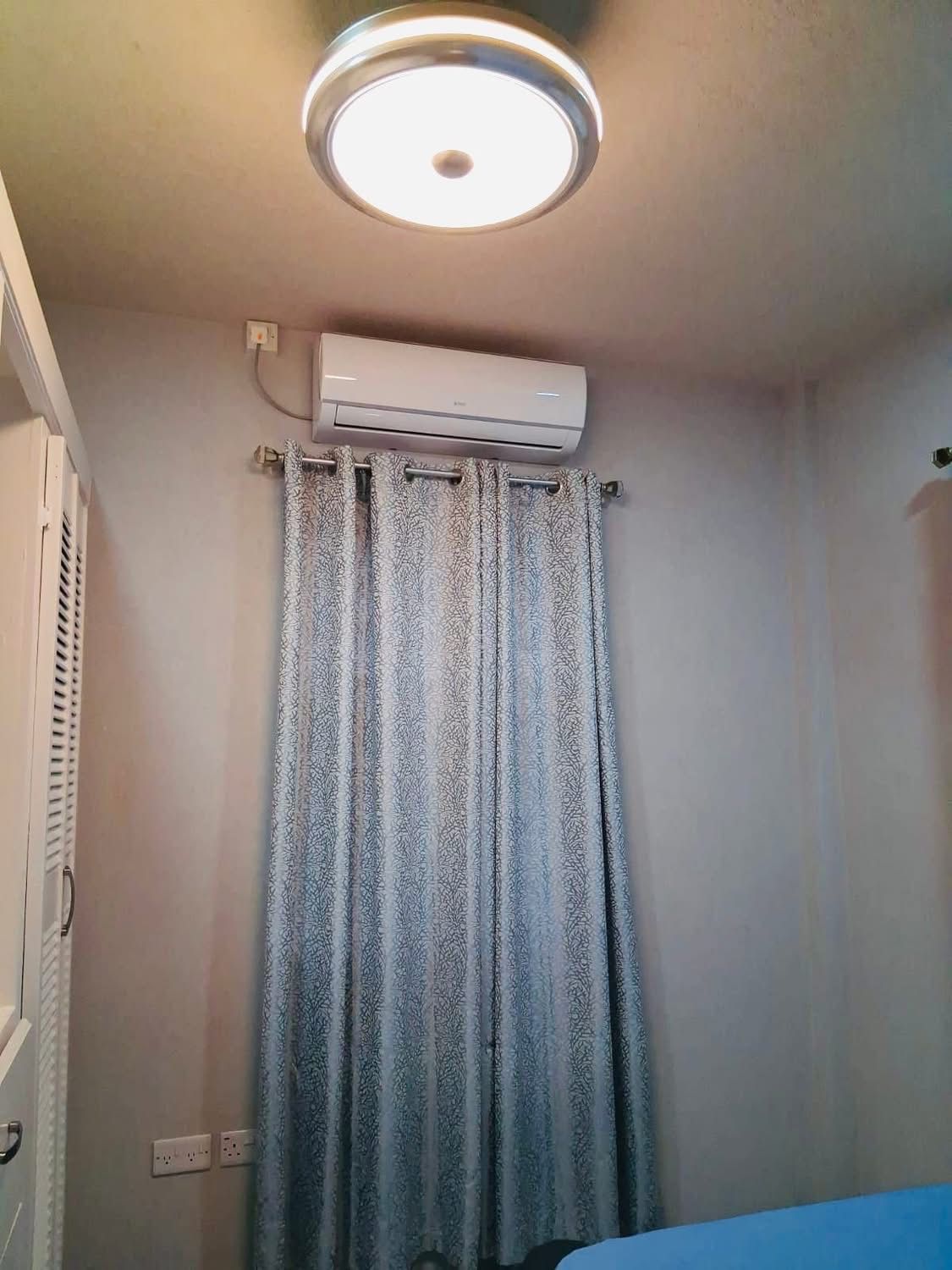 Bedroom featuring split-unit air conditioning and modern overhead lighting